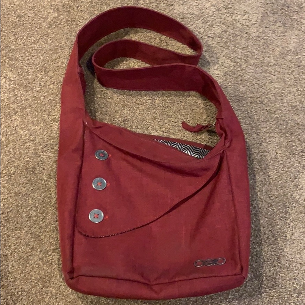 OGIO over the shoulder bag. Dark red color.